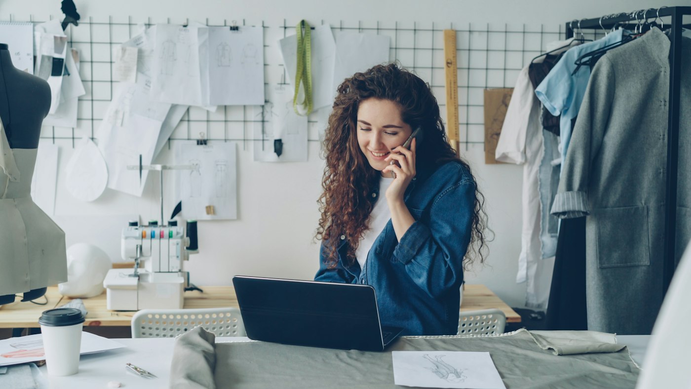 A business owner on the phone at her workbench